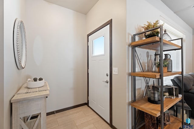 entrance foyer with a healthy amount of sunlight, light wood-style floors, and baseboards