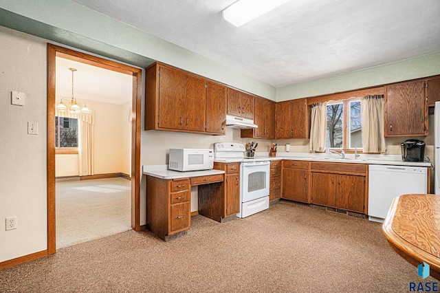 kitchen featuring under cabinet range hood, white appliances, brown cabinetry, and light countertops