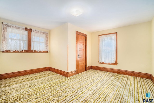 spare room with a healthy amount of sunlight and baseboards