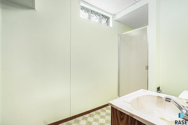 bathroom featuring tile patterned floors, vanity, and a shower with shower door