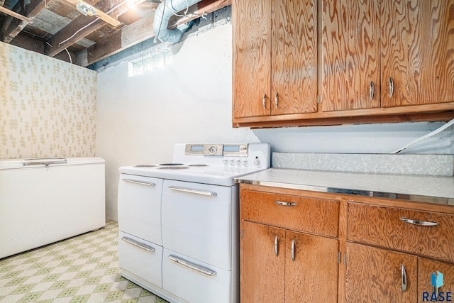 kitchen with light floors, light countertops, brown cabinets, and range with two ovens