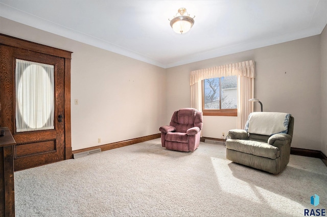 living area with carpet flooring, baseboards, crown molding, and visible vents