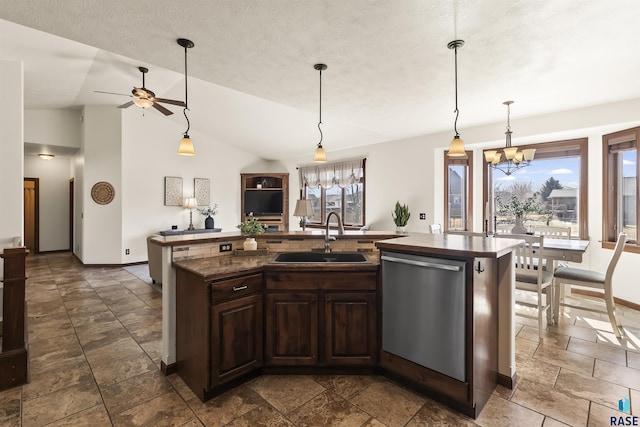 kitchen with a kitchen island with sink, a sink, dark countertops, stainless steel dishwasher, and dark brown cabinetry