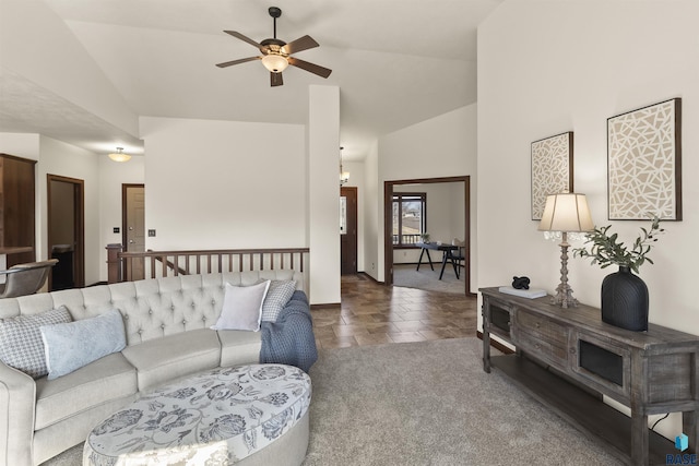 carpeted living area with stone finish floor, a ceiling fan, and high vaulted ceiling