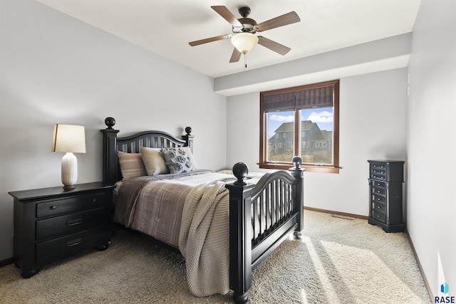 carpeted bedroom featuring baseboards and ceiling fan