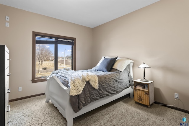 bedroom with light carpet and baseboards