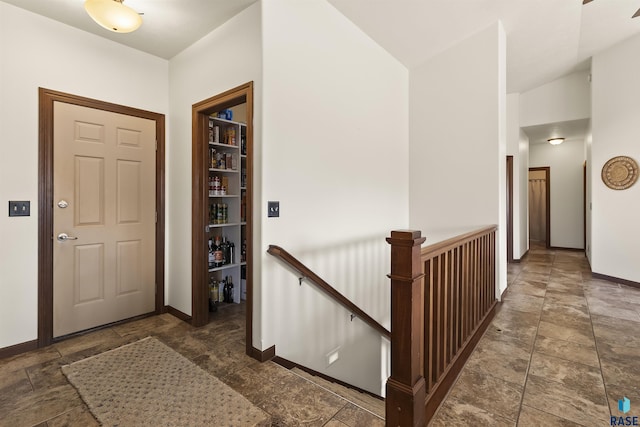 entryway featuring stone finish flooring and baseboards