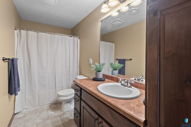 bathroom featuring vanity, tile patterned floors, toilet, and visible vents