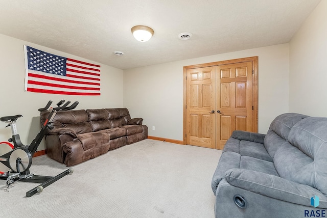 carpeted living room featuring visible vents and baseboards