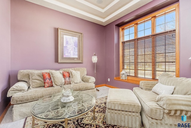 carpeted living room with baseboards