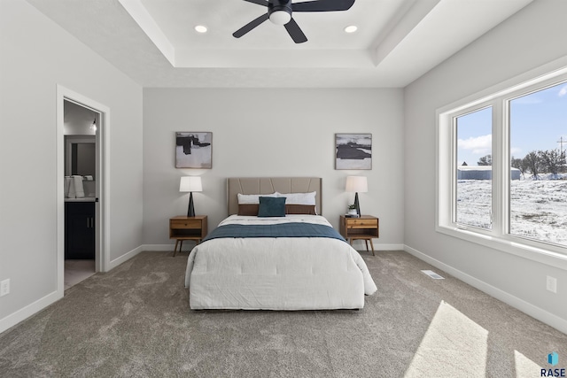 bedroom featuring recessed lighting, a tray ceiling, baseboards, and carpet floors