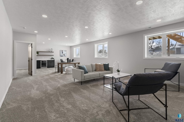 living room featuring carpet flooring, recessed lighting, a textured ceiling, and baseboards