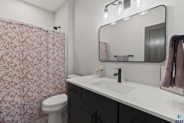 bathroom featuring tile patterned floors, toilet, and vanity