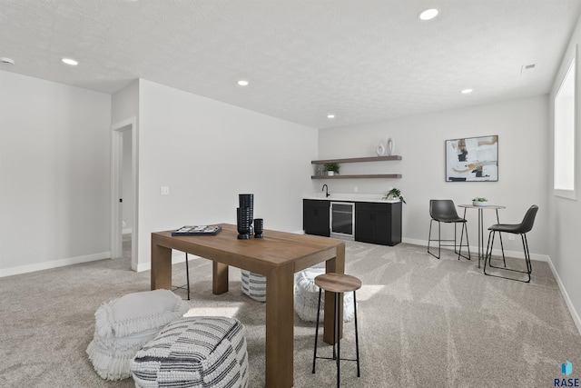 dining room featuring recessed lighting, indoor wet bar, light colored carpet, and beverage cooler