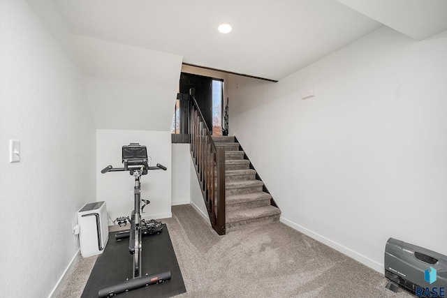 exercise area with baseboards and carpet