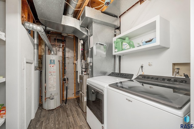 clothes washing area with laundry area, wood finished floors, water heater, and washing machine and clothes dryer