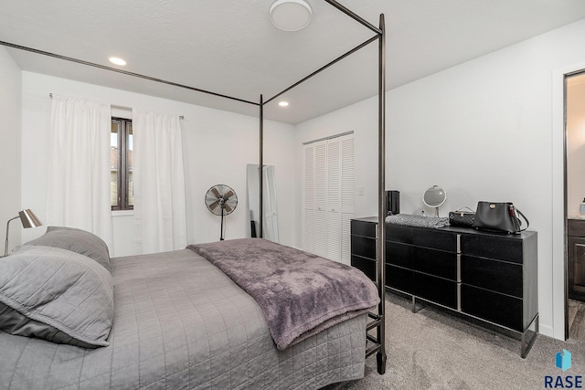 bedroom with a closet, carpet flooring, and recessed lighting