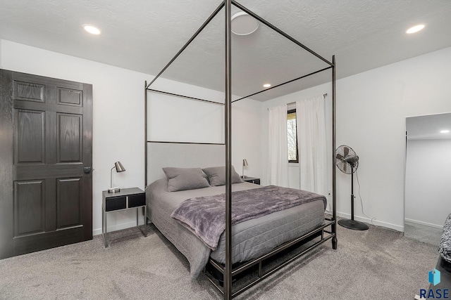 carpeted bedroom featuring recessed lighting, baseboards, and a textured ceiling