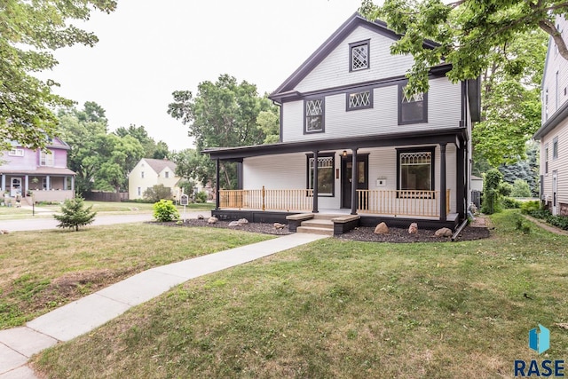 view of front of property with a porch and a front lawn