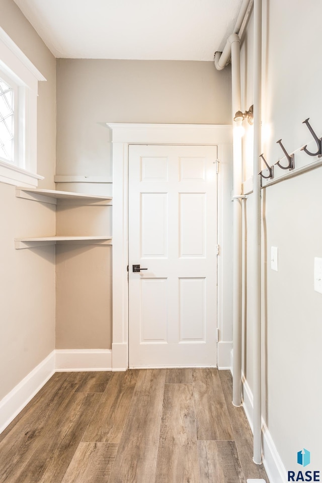 interior space featuring baseboards and wood finished floors