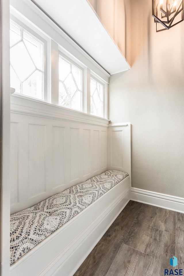 interior space with baseboards, dark wood-type flooring, and a chandelier