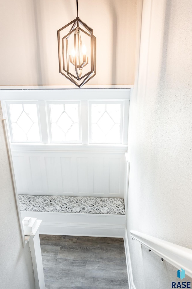 room details with a notable chandelier, wood finished floors, and baseboards