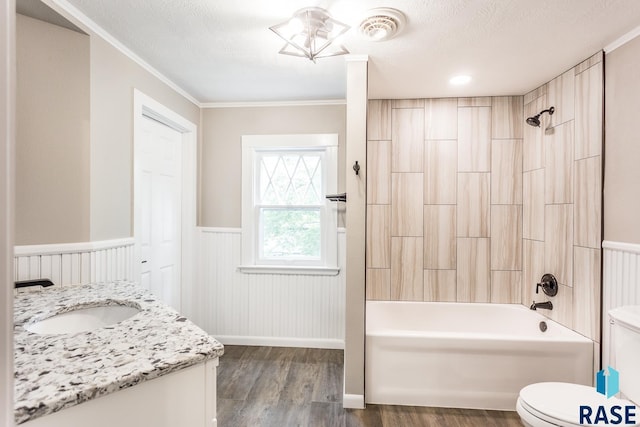 bathroom with visible vents, toilet, wainscoting, bathtub / shower combination, and wood finished floors