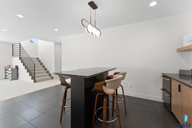 dining space featuring stairs, recessed lighting, and baseboards