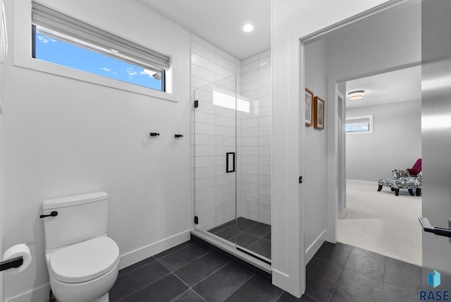 bathroom with baseboards, recessed lighting, a stall shower, tile patterned floors, and toilet