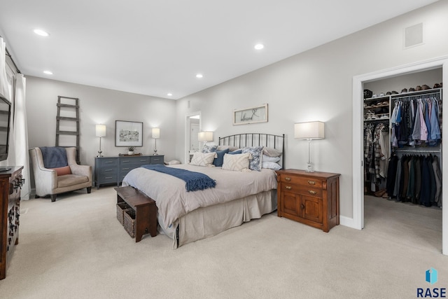 bedroom featuring visible vents, recessed lighting, a spacious closet, a closet, and light carpet