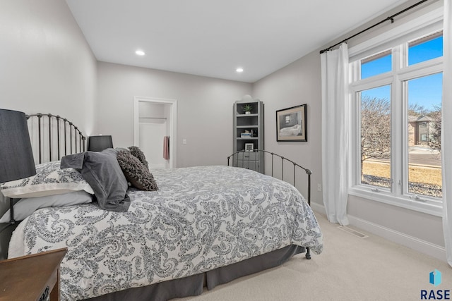 bedroom with light carpet, visible vents, recessed lighting, and baseboards