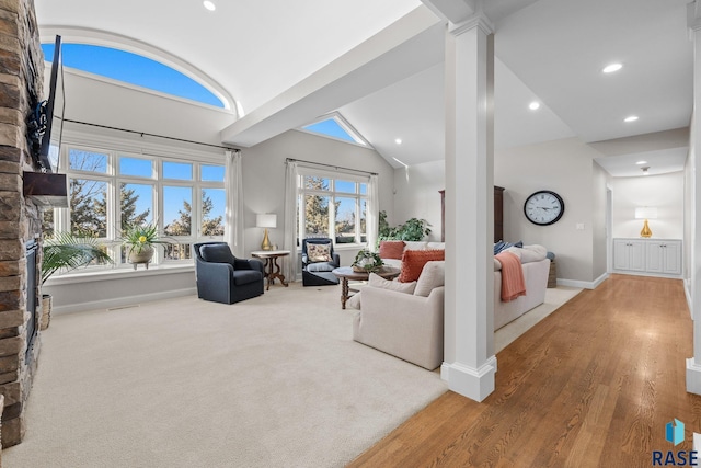 carpeted living room featuring lofted ceiling, recessed lighting, baseboards, and ornate columns