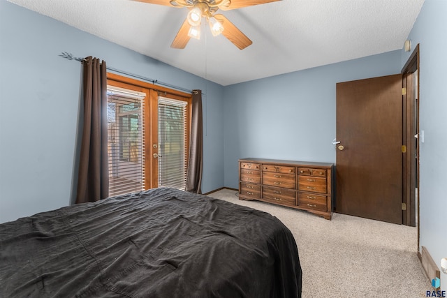 carpeted bedroom with a textured ceiling, access to outside, french doors, and ceiling fan