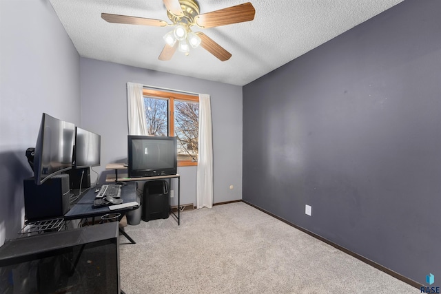 office area with carpet flooring, a ceiling fan, baseboards, and a textured ceiling