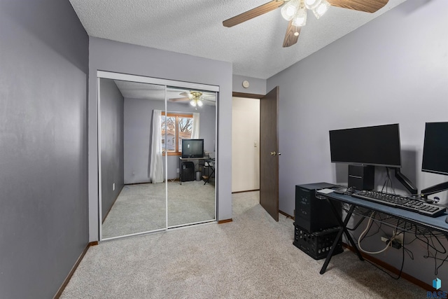 office area featuring ceiling fan, baseboards, carpet floors, and a textured ceiling