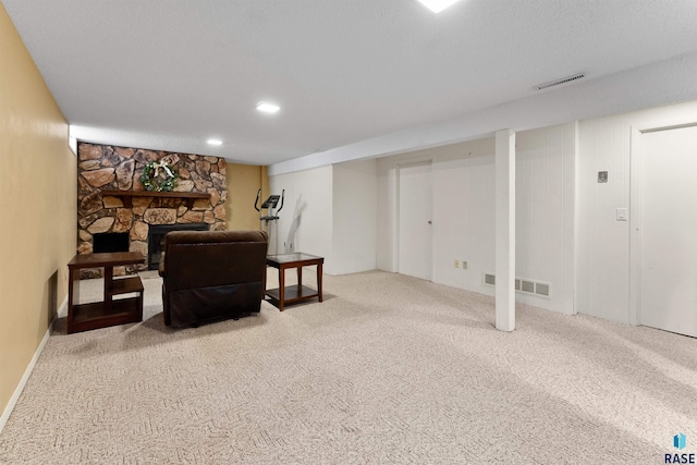 interior space with visible vents, carpet, and a fireplace