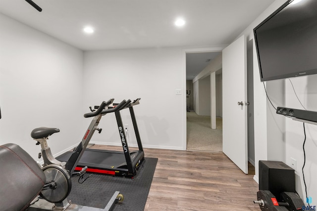 exercise room featuring recessed lighting, baseboards, and wood finished floors