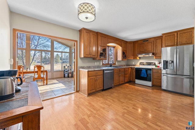 kitchen with a sink, brown cabinets, and appliances with stainless steel finishes