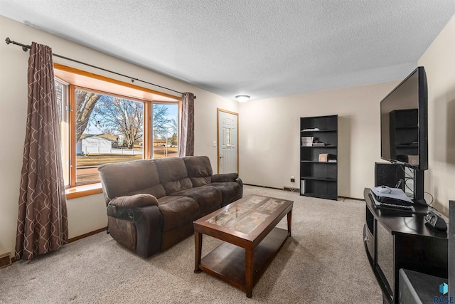 living room featuring baseboards, a textured ceiling, and carpet