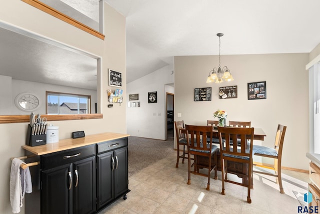 dining area featuring lofted ceiling, a notable chandelier, and light carpet