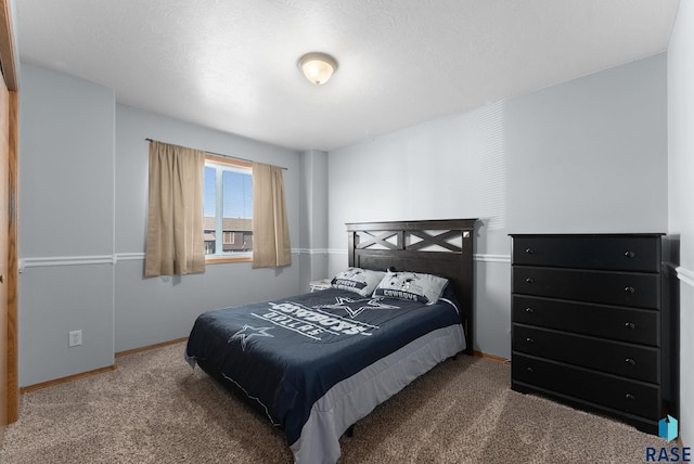 bedroom featuring baseboards and carpet