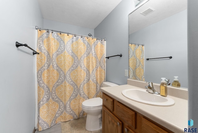 bathroom featuring visible vents, toilet, and vanity