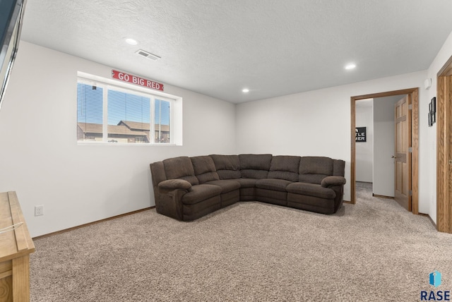 living area with carpet, baseboards, visible vents, recessed lighting, and a textured ceiling