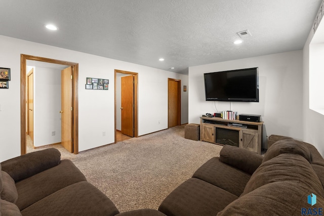 carpeted living room with recessed lighting, visible vents, and a textured ceiling