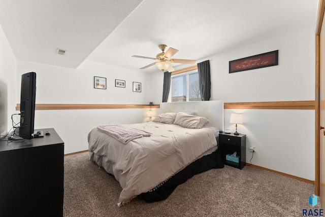 bedroom with baseboards, carpet floors, and a textured ceiling