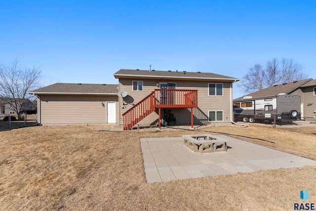 back of house with stairway, fence, a wooden deck, a fire pit, and a patio area