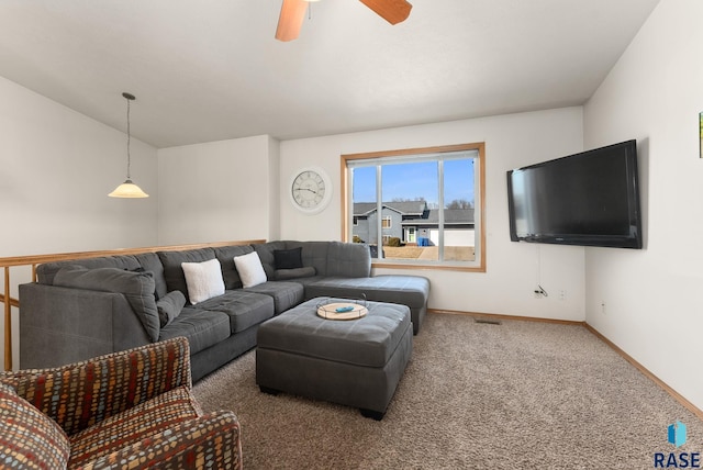 living area with baseboards, carpet floors, visible vents, and a ceiling fan