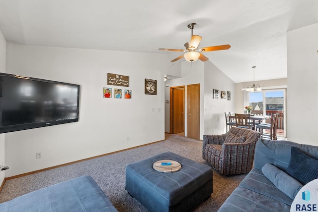 carpeted living area with baseboards, ceiling fan with notable chandelier, and vaulted ceiling