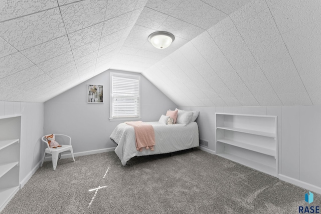 bedroom with visible vents, baseboards, carpet, and vaulted ceiling