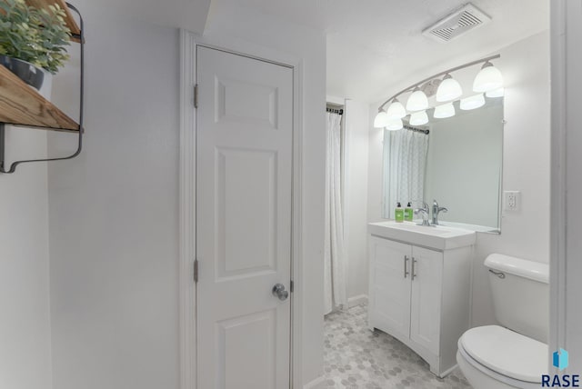 full bathroom featuring visible vents, toilet, and vanity